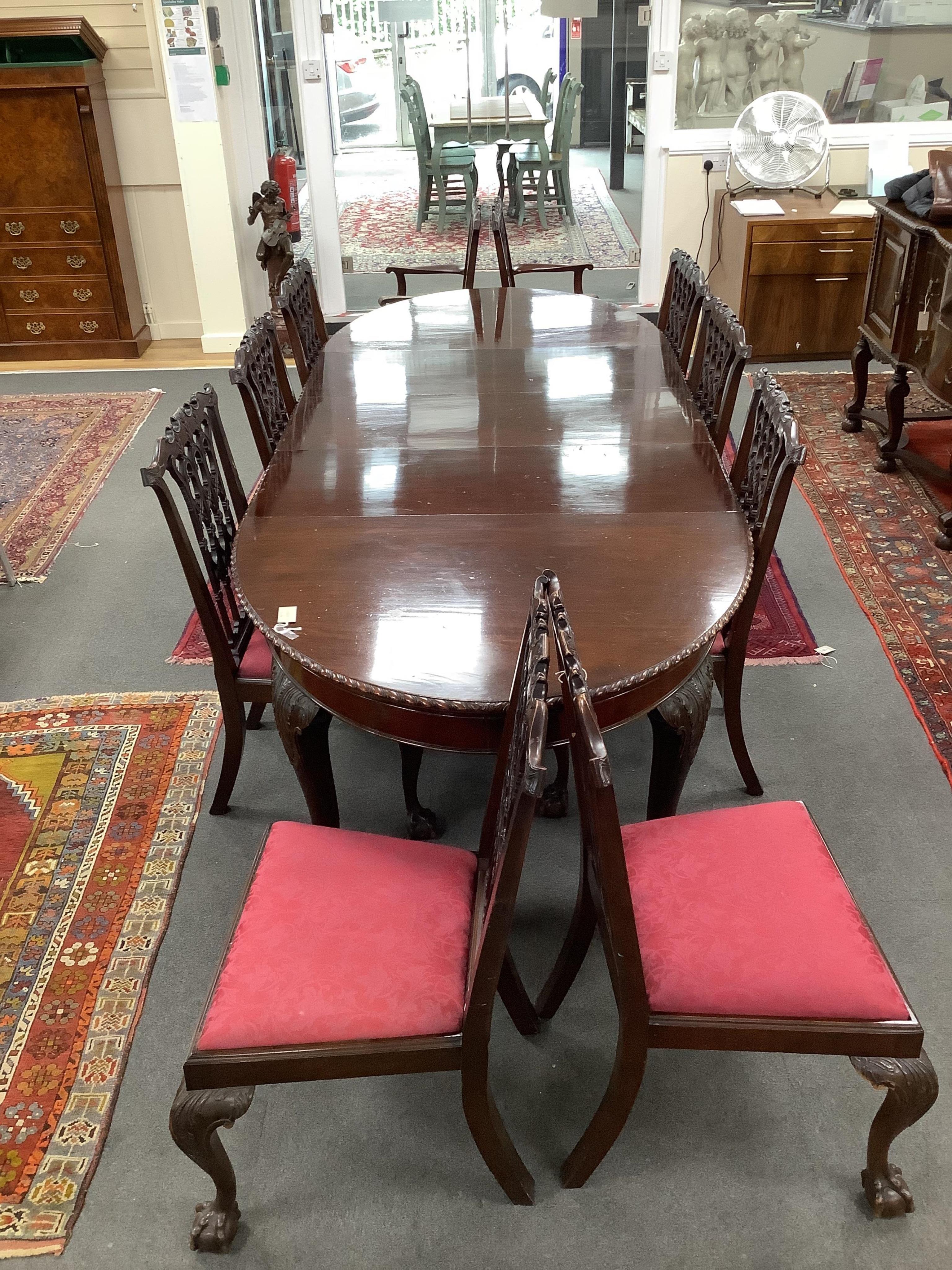 A Chippendale Revival mahogany dining suite comprising an extending dining table, width 300cm extended, depth 122cm, height 74cm, ten chairs (two with arms), a serpentine sideboard and a serving table. Condition - fair t